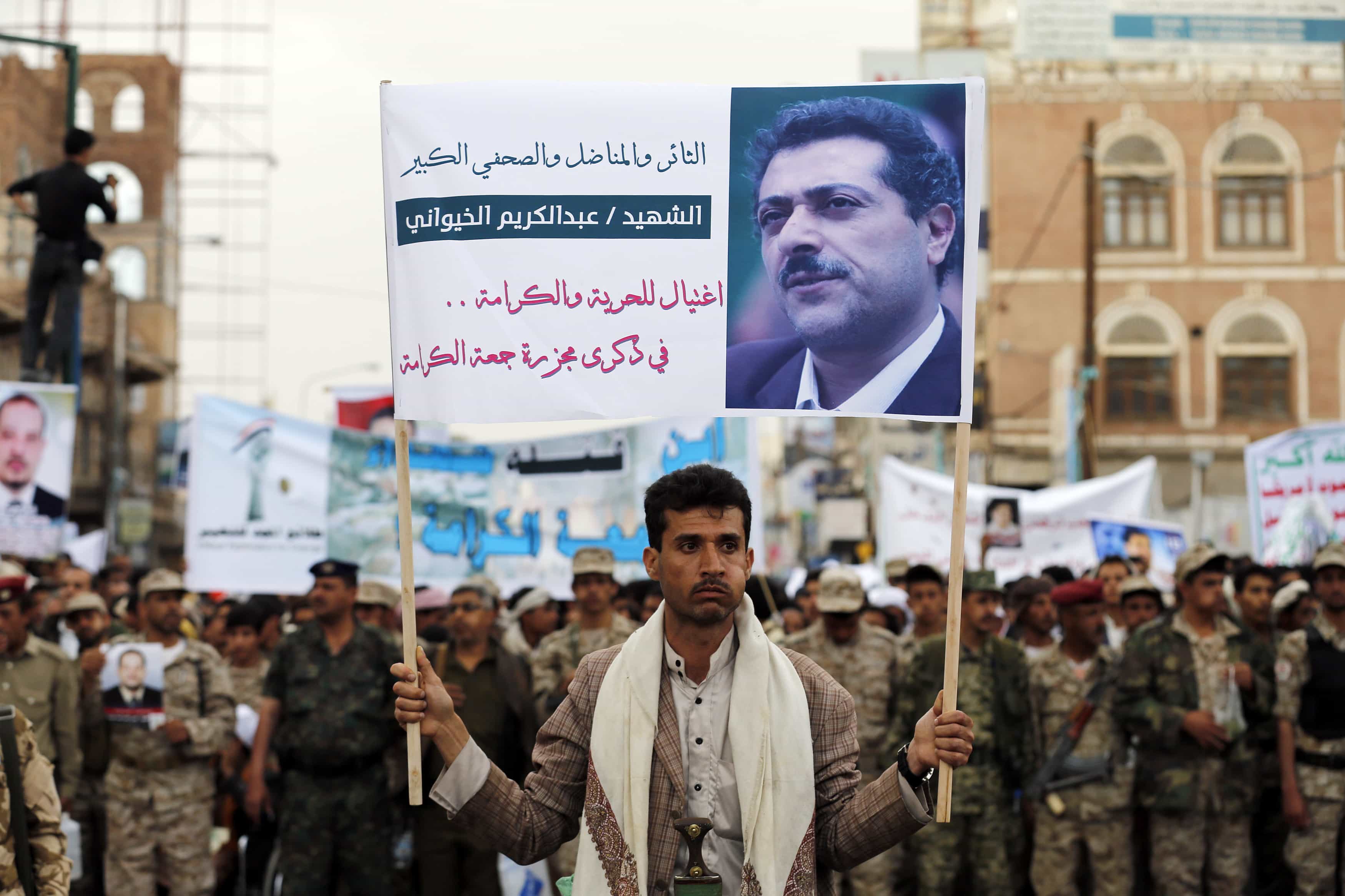 A follower of the Houthi movement holds up a banner depicting journalist Abdul Kareem al-Khaiwani during a demonstration commemorating an attack on pro-democracy protesters in Sanaa March 18, 2015, REUTERS/Khaled Abdullah