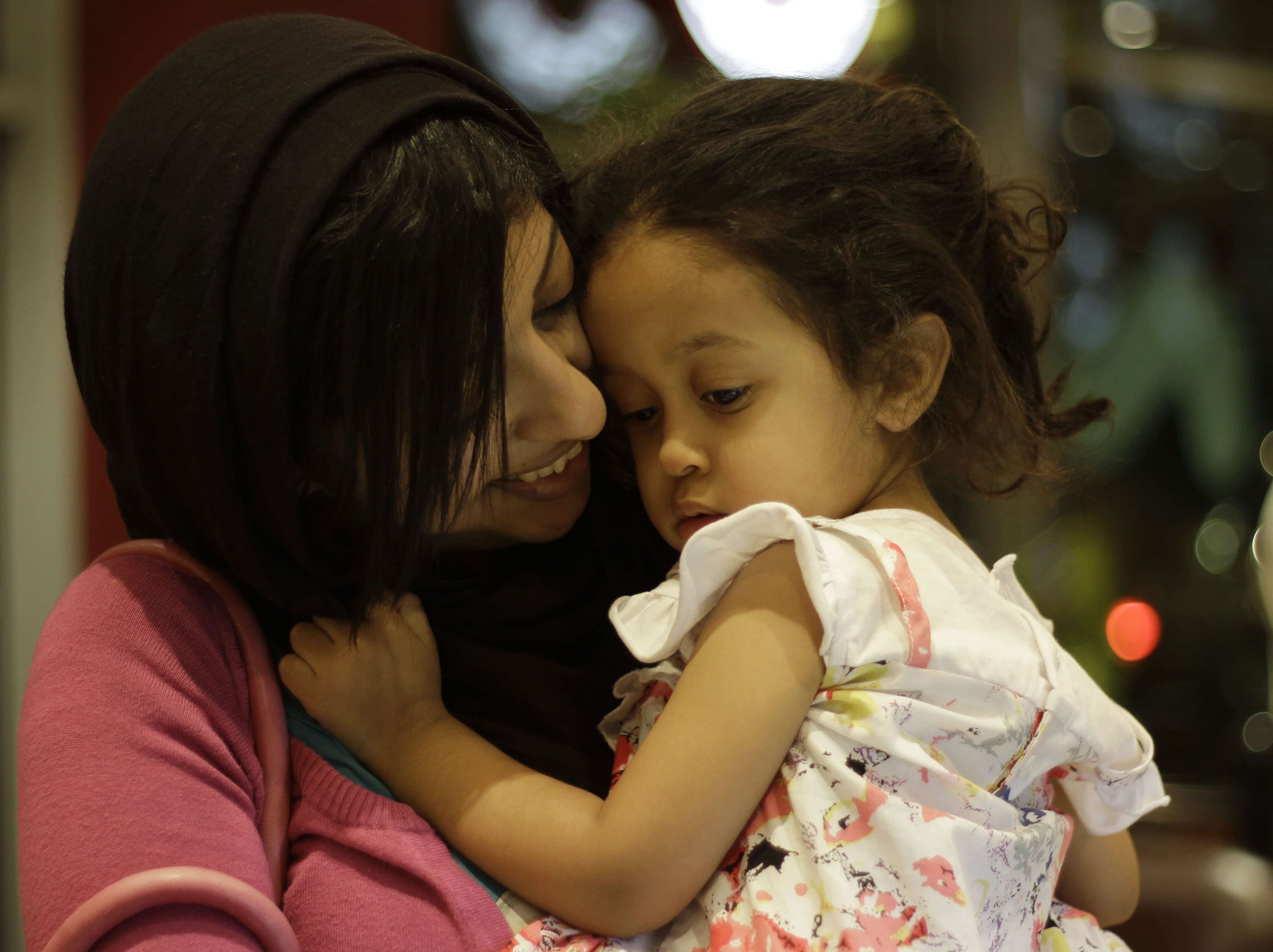 Bahraini human rights activist Zainab al-Khawaja holds her daughter Jude  at a coffee shop in Abu Saiba, Bahrain, (AP Photo/Hasan Jamali)