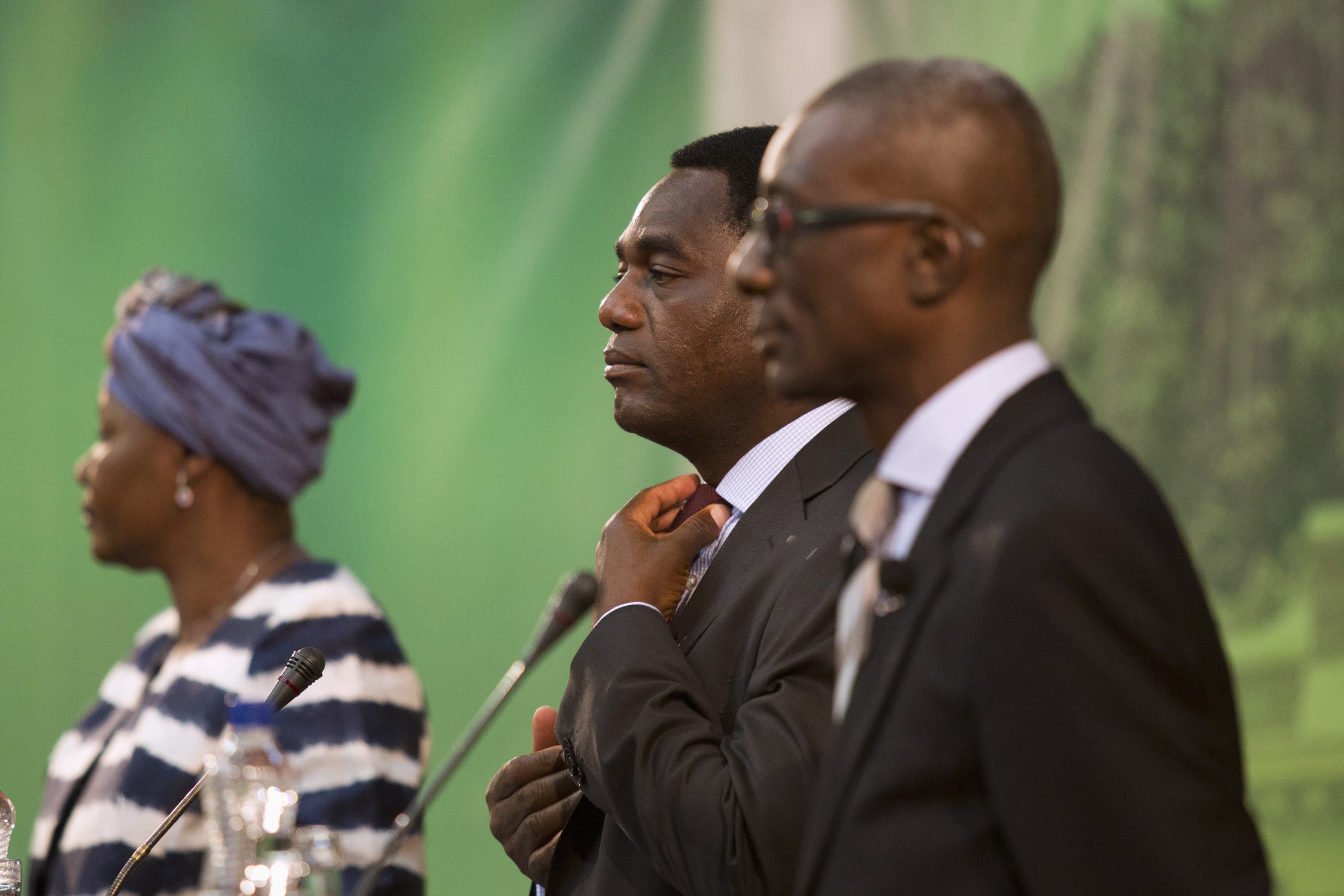 Presidential candidate for the UPND Hakainde Hichilema (C) straightens his tie during a live television debate in Lusaka, 15 January 2015, REUTERS/Rogan Ward