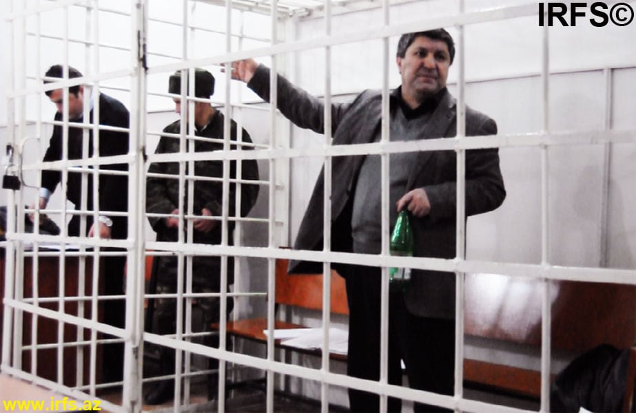 Avaz Zeynalli stands behind bars during his trial at the Grave Crimes Court of Baku on 26 December 2012., IRFS