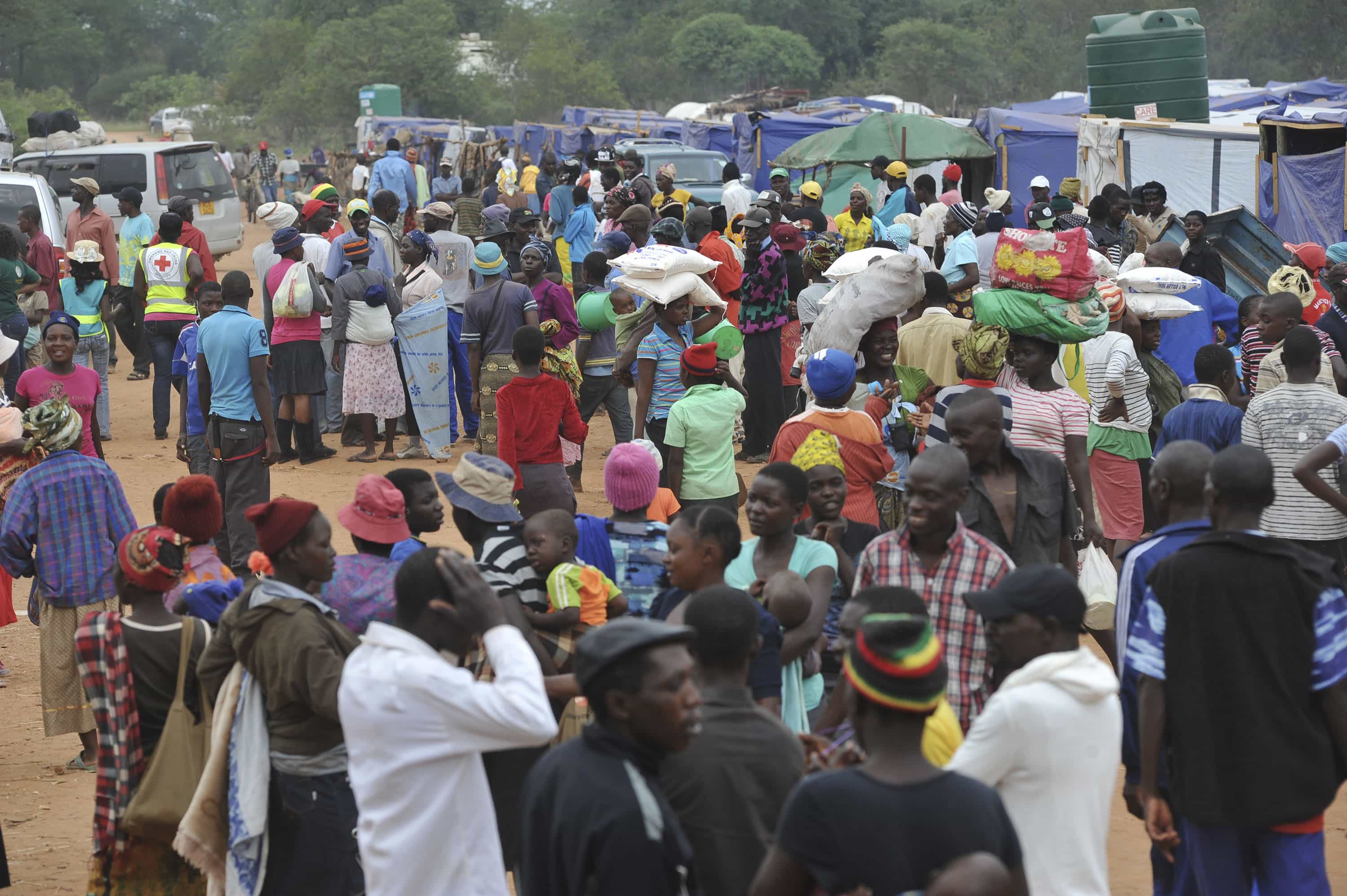 A large number of people at the Chingwizi transit Camp in the province of Masvingo, Zimbabwe can be seen waiting near the centre which distributes food aid to the residents of the camp., Ihsaan Haffejee/Demotix