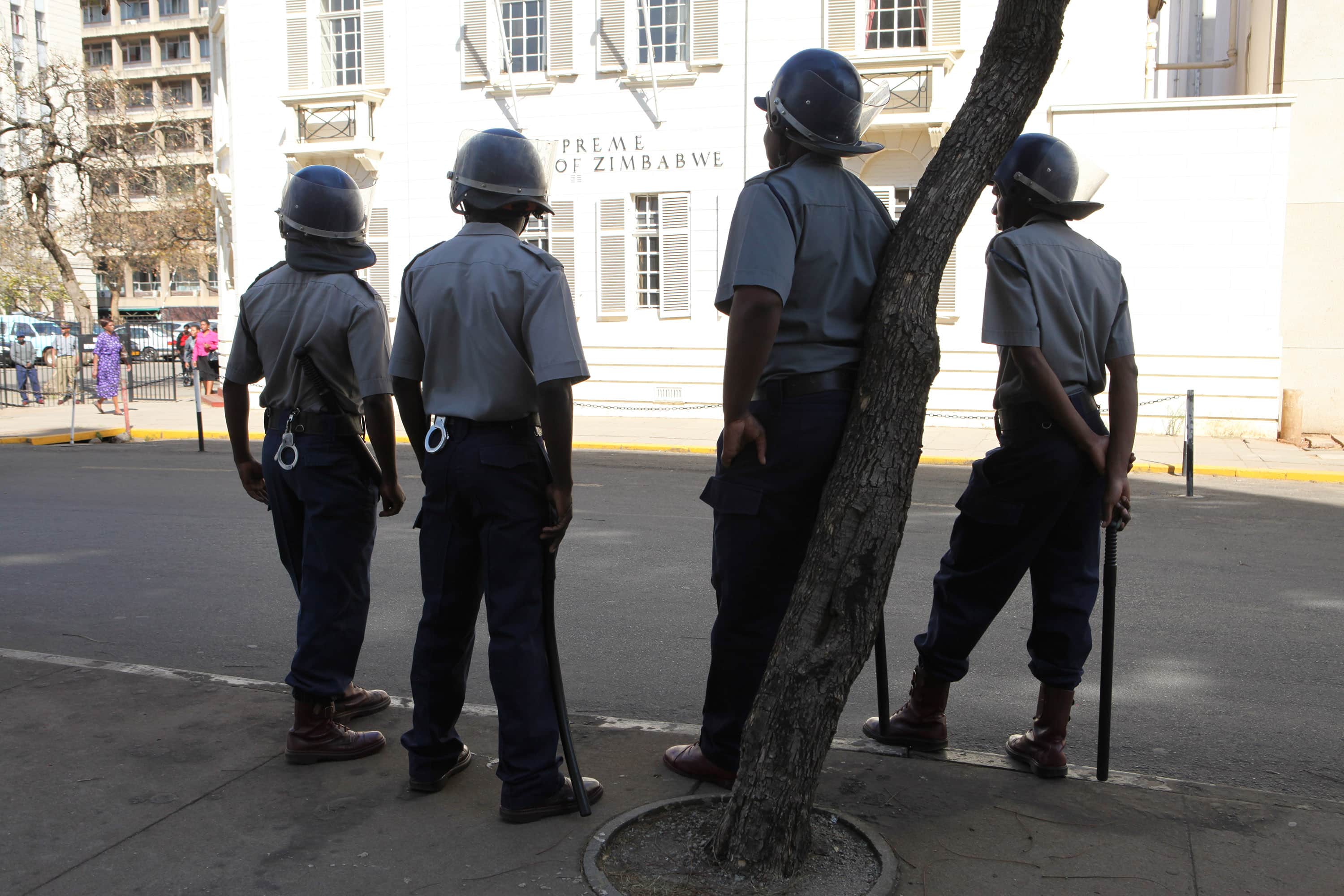 Zimbabwean police are seen outside the Supreme Court in Harare on 20 August 2013., AP Photo/Tsvangirayi Mukwazhi