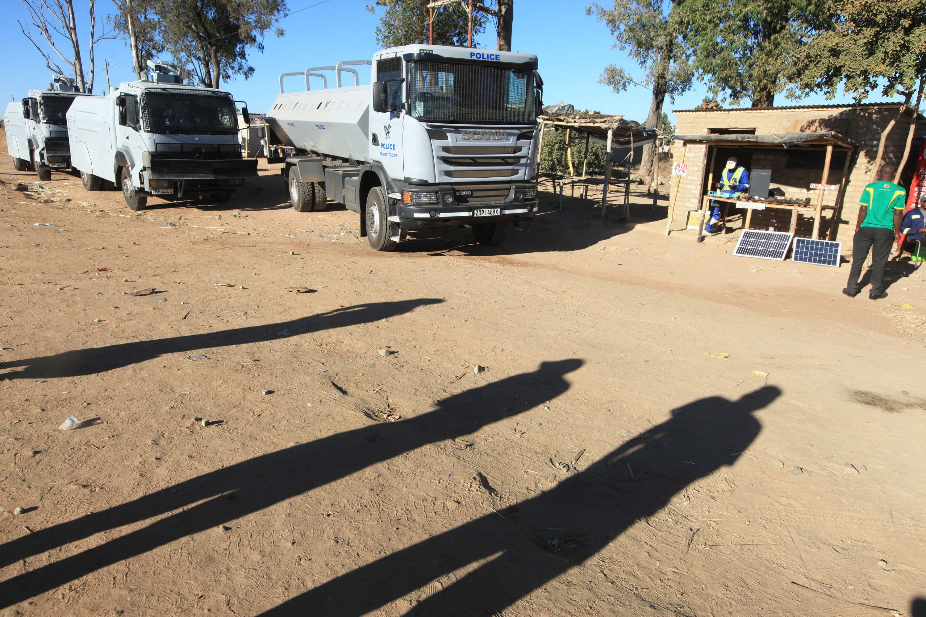 Police vehicles and water canons parked on the outskirts of the city following a job boycott started via social media platforms, in Harare, 6 July 2016, AP Photo/Tsvangirayi Mukwazhi