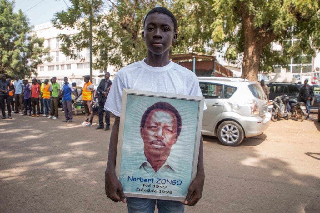 A man takes part in a demonstration to mark the 20th anniversary of the assassination of Burkinabe investigative reporter Norbert Zongo, in Ouagadougou, Burkina Faso, 13 December 2018, OLYMPIA DE MAISMONT/AFP/Getty Images