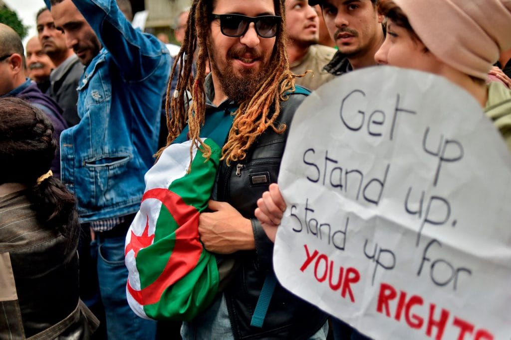 Algerian protesters demonstrate against their ailing president's bid for a fifth term in power, in Algiers, 8 March 2019, RYAD KRAMDI/AFP/Getty Images