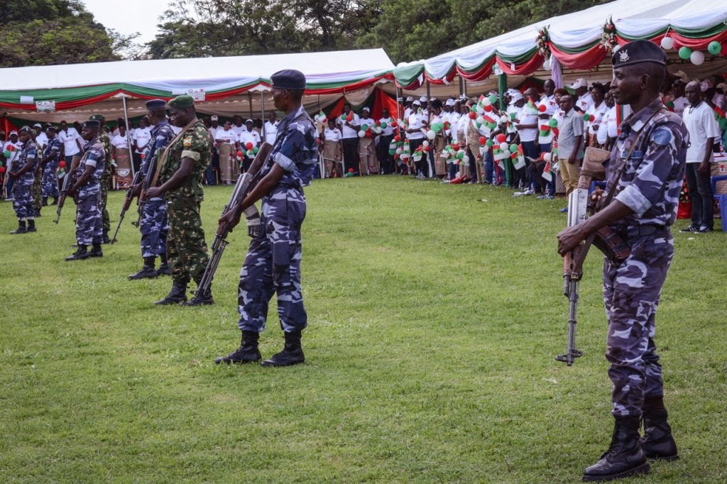 Security officers stand guard during a campaign by Burundi's ruling CNDD-FDD party for a referendum, in Bujumbura, 14 May 2018, STR/AFP/Getty Images