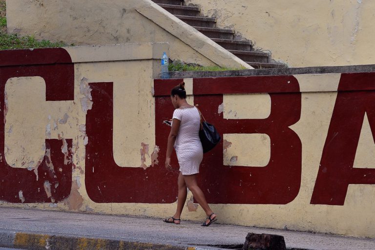 A woman connects to the internet from her mobile phone in Havana, Cuba, 17 March 2019, YAMIL LAGE/AFP/Getty Images