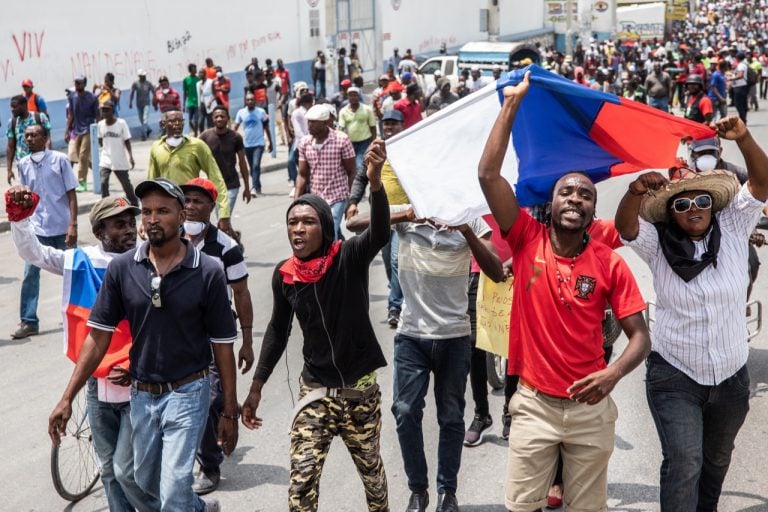 People demonstrate through the streets of Port-au-Prince, Haiti, on 29 March 2019, demanding the removal of President Jovenel Moïse, VALERIE BAERISWYL/AFP/Getty Images