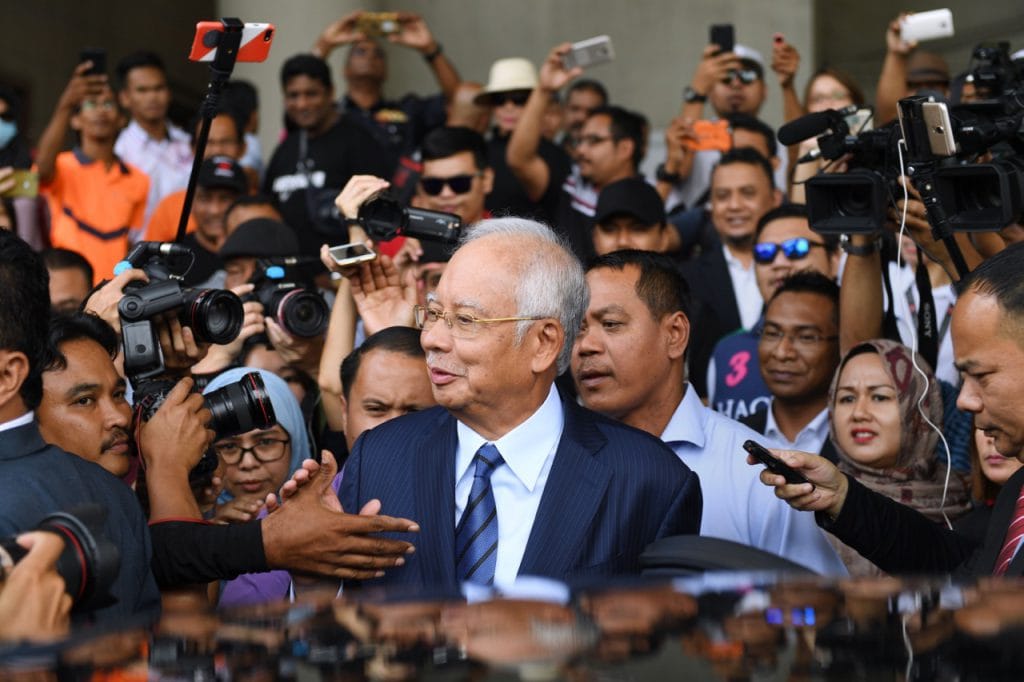 Former prime minister Najib Razak greets supporters as he leaves the courthouse after being charged, in Kuala Lumpur, Malaysia, 12 December 2018, MOHD RASFAN/AFP/Getty Images