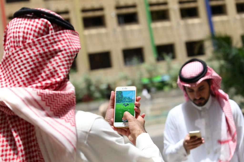 Saudi men on their mobiles in the capital Riyadh, 17 July 2016, STRINGER/AFP/Getty Images