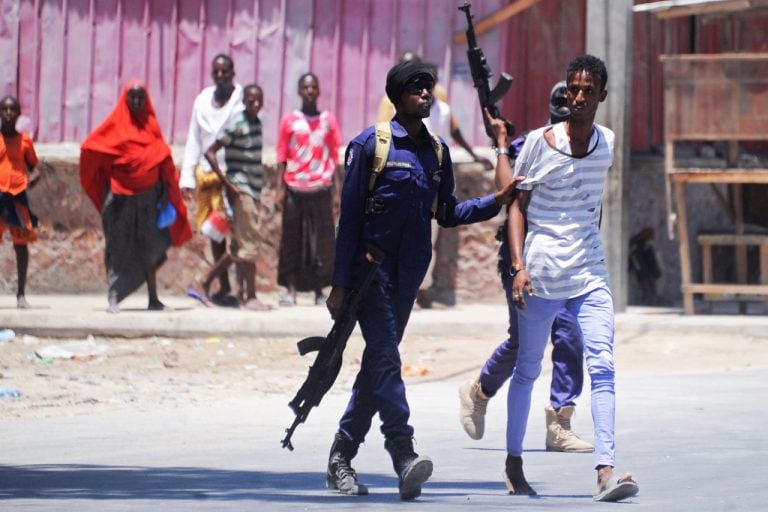 Somali soldiers arrest a civilian close to the scene of two explosions in Mogadishu, 23 March 2019, MOHAMED ABDIWAHAB/AFP/Getty Images