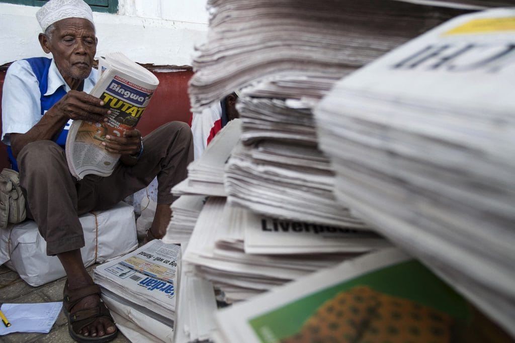 A newspaper vendor sorts the morning papers as they arrive by ferry from the mainland in Stone Town, Zanzibar, 2 November 2015, Daniel Hayduk/AFP/Getty Images