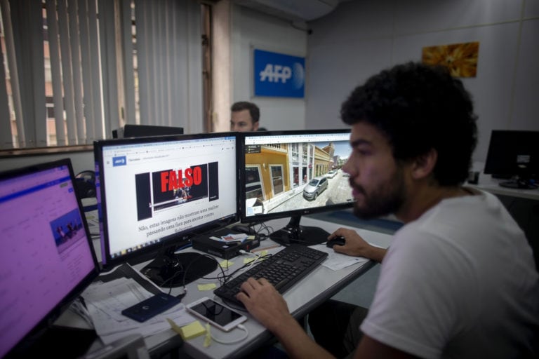 An AFP fact-checking team works in Rio de Janeiro, Brazil ahead of first round elections, September 27, 2018, MAURO PIMENTEL/AFP/Getty Images)