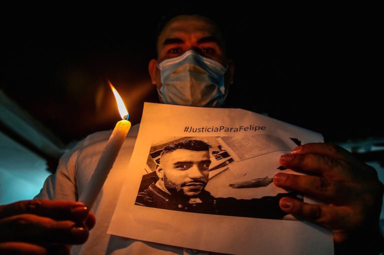 A member of the press pays tribute to journalist Felipe Guevara, who died earlier, two days after being shot, in Cali, Colombia, 23 December 2020, PAOLA MAFLA/AFP via Getty Images