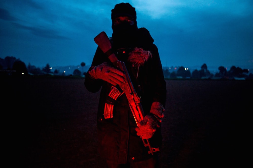 A local police officer is seen before a patrol in Butembo, north of Kivu, 18 May 2019, as Ebola treatment centres were coming under attack by the Mai-Mai rebel group. JOHN WESSELS/AFP via Getty Images