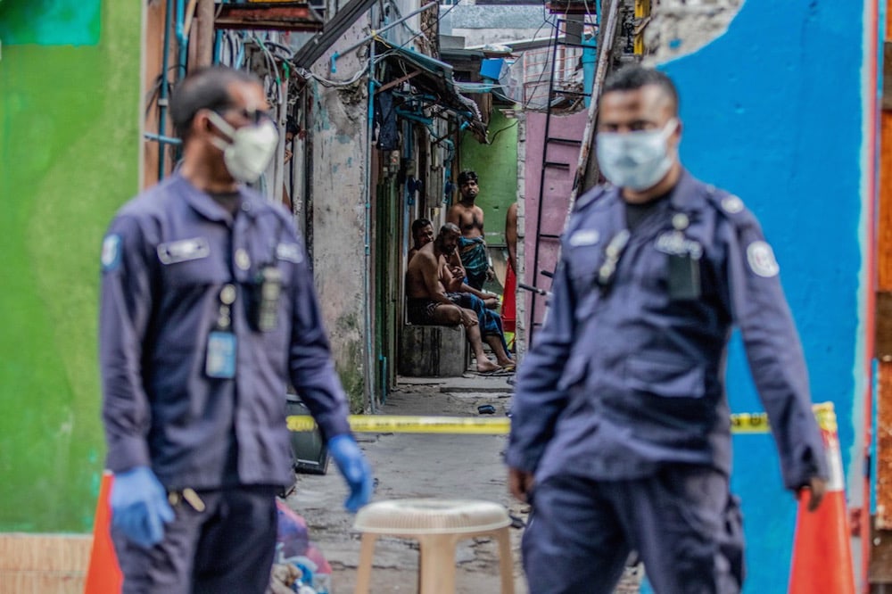 Security personnel patrol an accommodation block where Bangladeshi migrant workers are being quarantined after Covid-19 cases were found in the area, Malé, Maldives, 9 May 2020, Ahmed Shurau/AFP via Getty Images