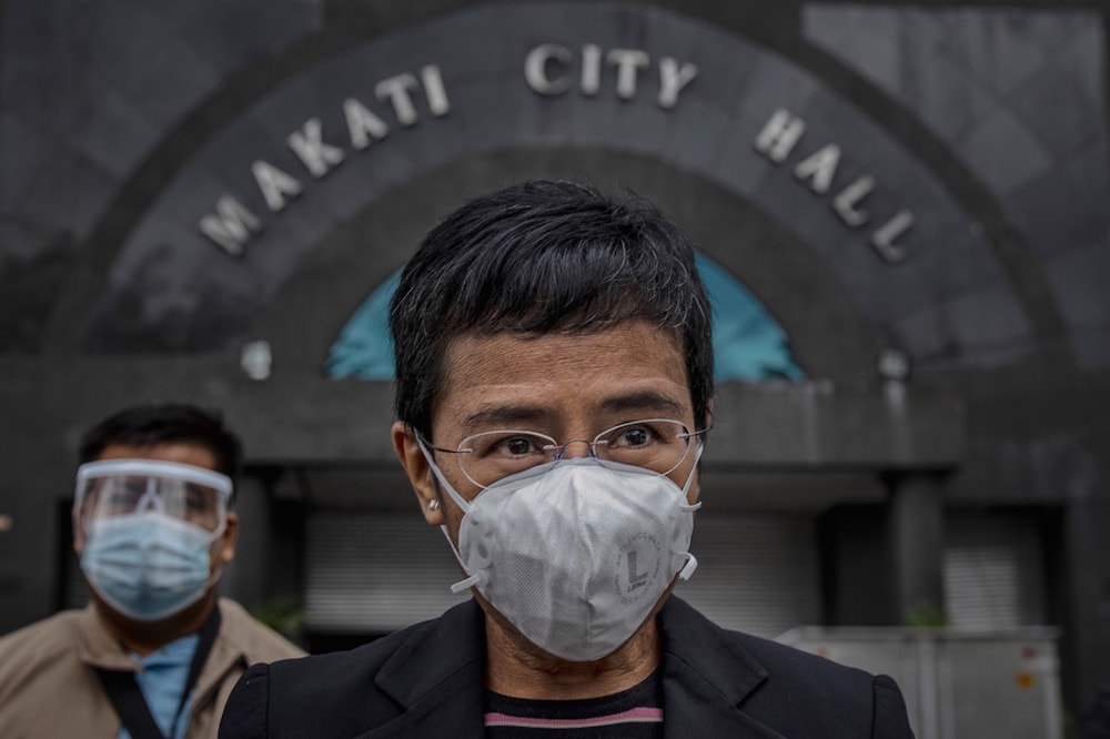 Maria Ressa, founder of news portal "Rappler", faces reporters after appearing in court for a second "cyber-libel" charge against her, in Makati, Philippines, 15 December 2020, Ezra Acayan/Getty Images