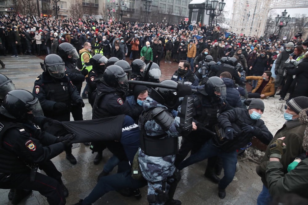 Riot police officers use truncheons to beat some protesters while arresting others, during a rally in support of jailed opposition activist Alexei Navalny, in Pushkinskaya Square, Moscow, Russia, 23 January 2021, Valery SharifulinTASS via Getty Images
