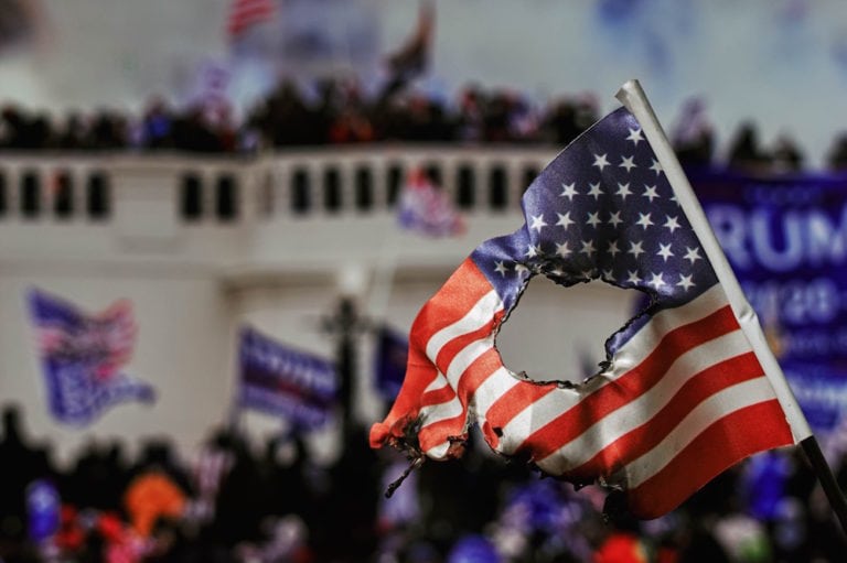 A burnt U.S. flag at the Capitol Hill riot, Washington, D.C., 9 January 2021, photographer Marco Verch, https://foto.wuestenigel.com/the-deadly-capitol-hill-riots/, Attribution 2.0 Generic (CC BY 2.0)