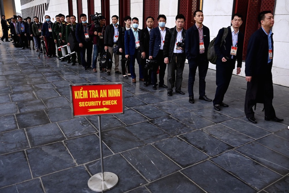 Media persons wait in line for a security check before the start of the opening session of the National Party Congress, in Hanoi, Vietnam, 26 January 2021, MANAN VATSYAYANA/AFP via Getty Images