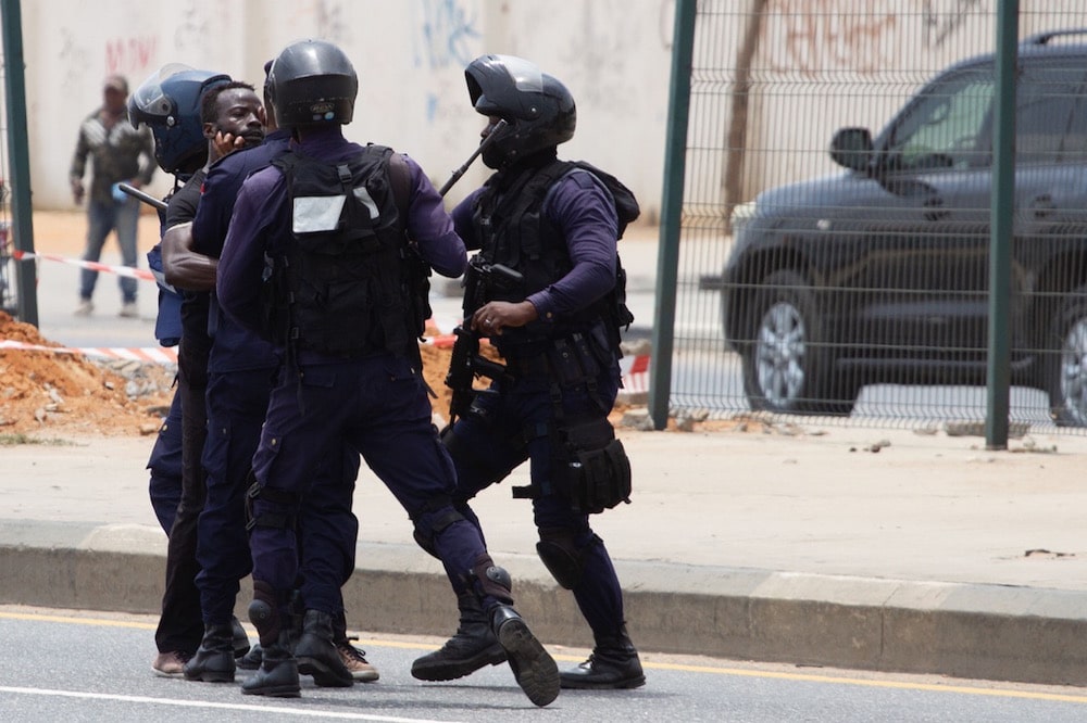 A protester is detained by police during a demonstration against police brutality, in Luanda, Angola, 4 February 2021, OSVALDO SILVA/AFP via Getty Images