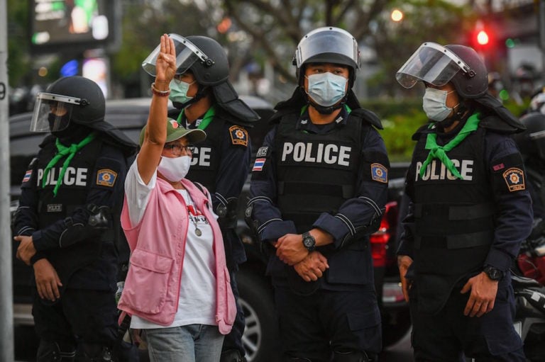 A protester uses a three-finger salute (from the "Hunger Games" movies) during a demonstration calling for the release of activists arrested under the Lèse-majesté law, Bangkok, Thailand, 16 January 2021, Amphol Thongmueangluang/SOPA Images/LightRocket via Getty Images