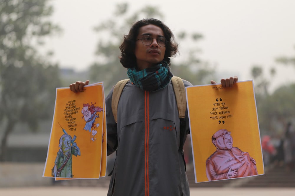 A student activist holds a copy of Kishore's cartoons during demanding his release of and that of writer Mushtas Ahmed (now deceased), who had been detained under the Digital Security Act, Dhaka, Bangladesh 24 January 2021, Rehman Asad/NurPhoto via Getty Images