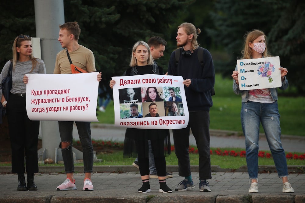 People hold posters reading 'Where do Belarusian journalists end up when they go to work?', 'They did their job and ended up in Okrestina' [detenion centre], and 'Free Minsk From Violence' during a rally in support of detained journalists, Minsk, Belarus, 3 September 2020, Natalia FedosenkoTASS via Getty Images