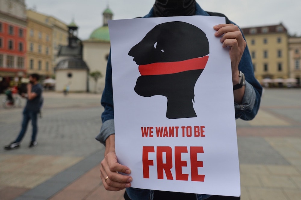 An activist holds a banner that reads 'We want to be free' during a rally in solidarity with Belarusian political prisoners, in Krakow, Poland, 3 July 2020, Artur Widak/NurPhoto