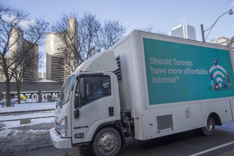A truck with an electronic sign calling attention to the high prices of internet services passes by the City Hall, in downtown Toronto, Canada, 26 January 2021, CORONAPD Toronto Star/Rick Madonik