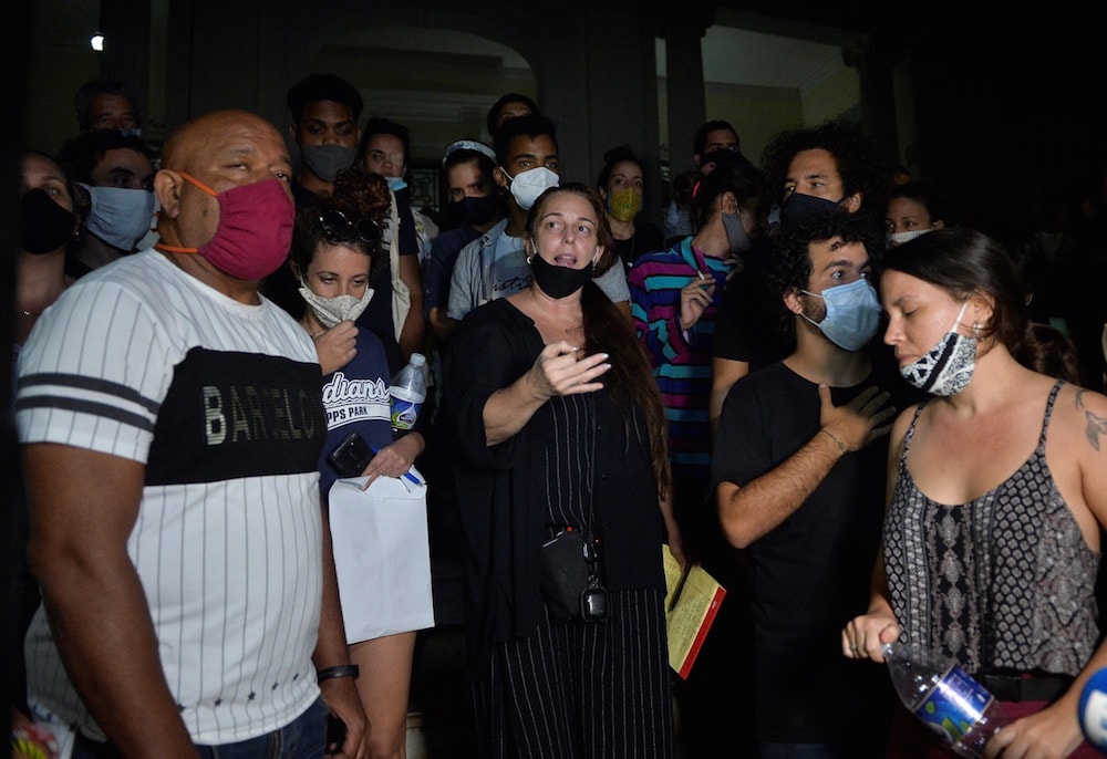 Performance artist Tania Bruguera (C) reads discussion points outside the Ministry of Culture after a meeting with the Vice Minister of Culture, Havana, Cuba, 28 November 2020, YAMIL LAGE/AFP via Getty Images