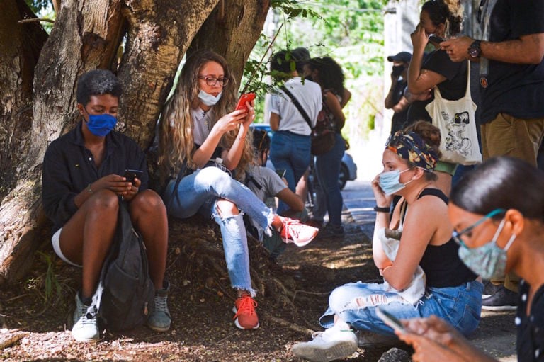 Cubans use their cell phones to connect to the Internet during a gathering outside the Ministry of Culture, Havana, Cuba, 27 November 2020, YAMIL LAGE/AFP via Getty Images