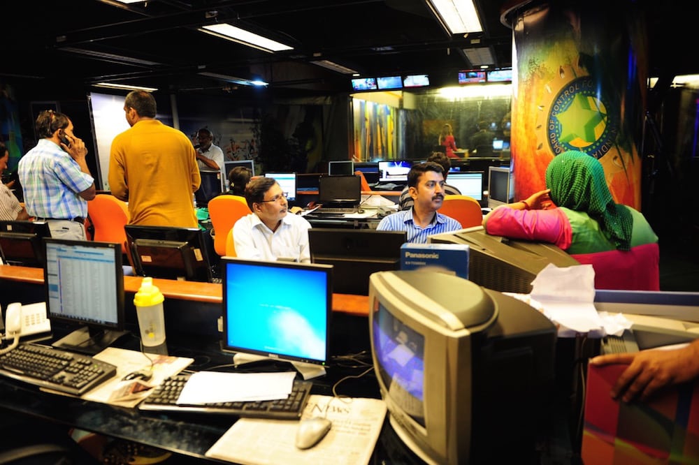 Journalists gather in the newsroom of Geo television, in Karachi, Pakistan, 6 June 2014, ASIF HASSAN/AFP via Getty Images