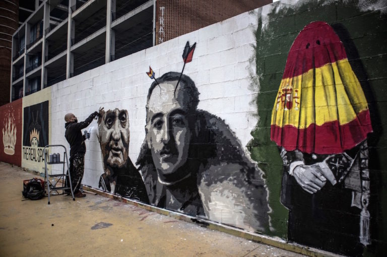 Graffiti artist Roc Blackblock creates an artwork in support of imprisoned rap artist Pablo Hásel, at the Tres Xemeneies park in Barcelona, Spain, 21 February 2021, Finbarr O'Reilly/Getty Images