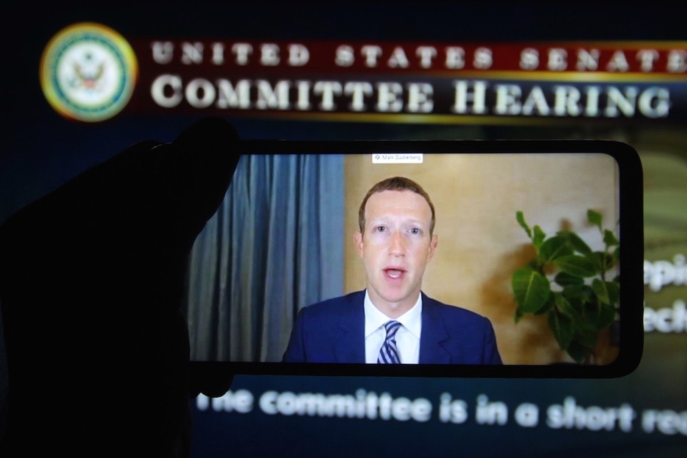 Facebook CEO Mark Zuckerberg is seen on a mobile screen as he remotely testifies during a hearing on Section 230 by the U.S. Senate Committee on Commerce, Science, and Transportation, Washington, D.C., photo Illustration by Pavlo Conchar/SOPA Images/LightRocket via Getty Images