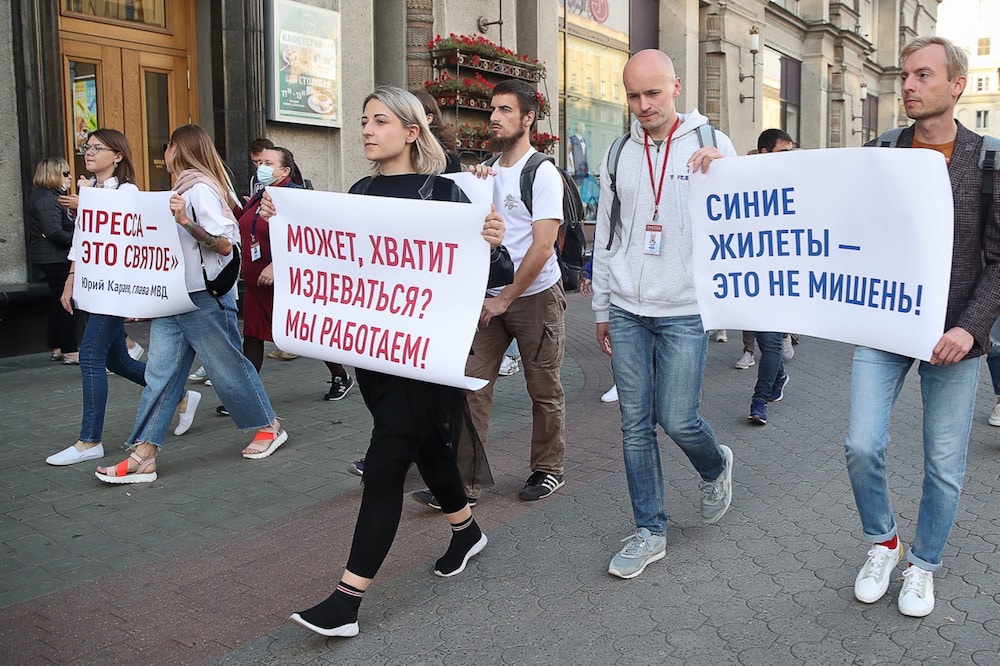 People carry posters that read 'The press is sacred', 'Stop bullying [us], we're working' and 'Blue vests are not a target', during a rally in support of journalists detained during protests, Minsk, Belarus, 3 September 2020, Natalia FedosenkoTASS via Getty Images