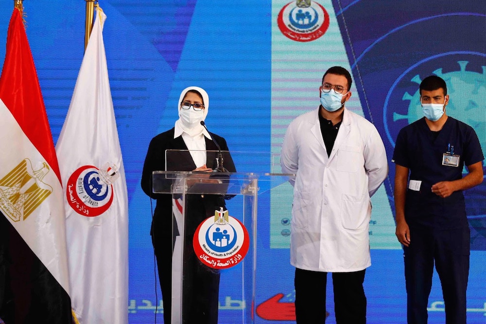 The Egyptian Health Minister (L) gives a press conference, accompanied by a doctor and a medical staff member in a tent set up outside a hospital, in Ismailia, Egypt, 24 January 2021, KHALED DESOUKI/AFP via Getty Images