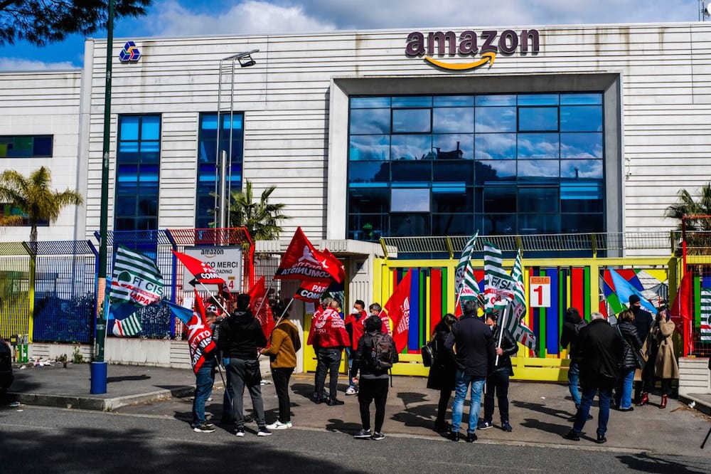 Amazon workers gather in front of the building's main gate during a national strike by thousands of drivers, hub and warehouse workers, in Aversa, Campania, Italy, 22 March 2021, Antonio Balasco/KONTROLAB/LightRocket via Getty Images