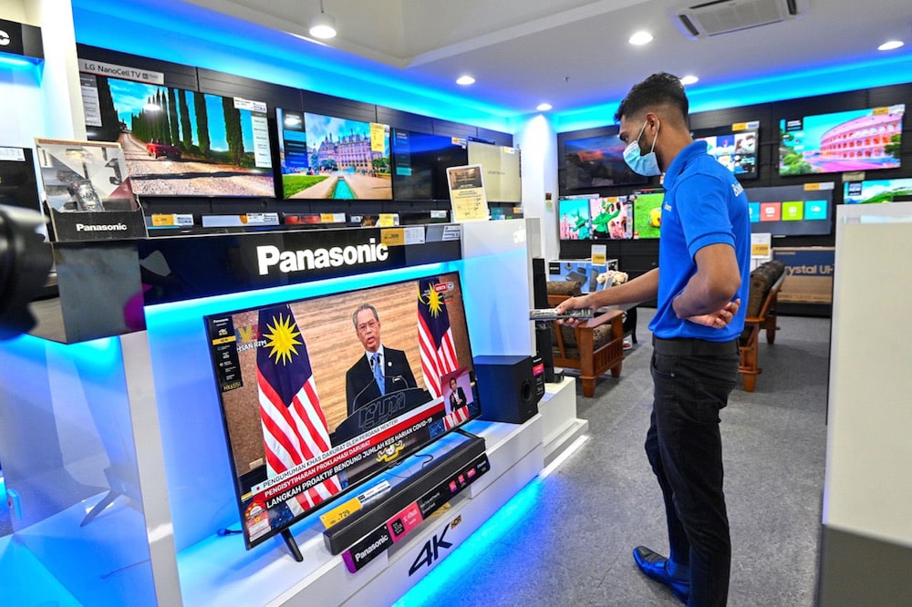 A speech by Prime Minister Muhyiddin Yassin is broadcast on TV as he declares a state of emergency, Kuala Lumpur, Malaysia, 12 January 2021, Xinhua/Chong Voon Chung via Getty Images