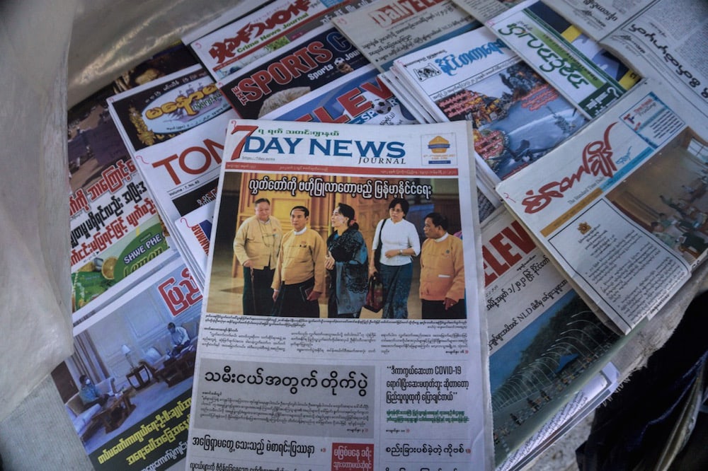 A copy of "7Day News" and other papers are displayed in Yangon, Myanmar, 2 February 2021, a day after the military seized power and detained democratically elected leader Aung San Suu Kyi. STR/AFP via Getty Images
