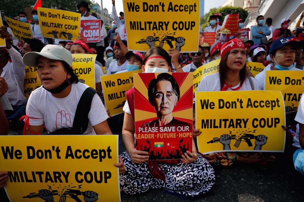 Protesters hold signs during a demonstration against the military coup near Sule Pagoda in central Yangon, Myanmar, 22 February 2021, Myat Thu Kyaw/NurPhoto via Getty Images