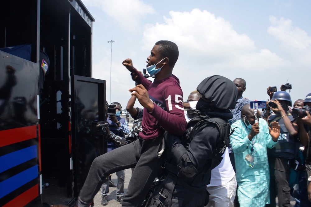 Lekki tollgate in Lagos, Nigeria, 13 February 2021. Police officers arrest a protester during a demonstration against police brutality and calling for justice for those killed at the #EndSARS protests in October 2020, Olukayode Jaiyeola/NurPhoto via Getty Images