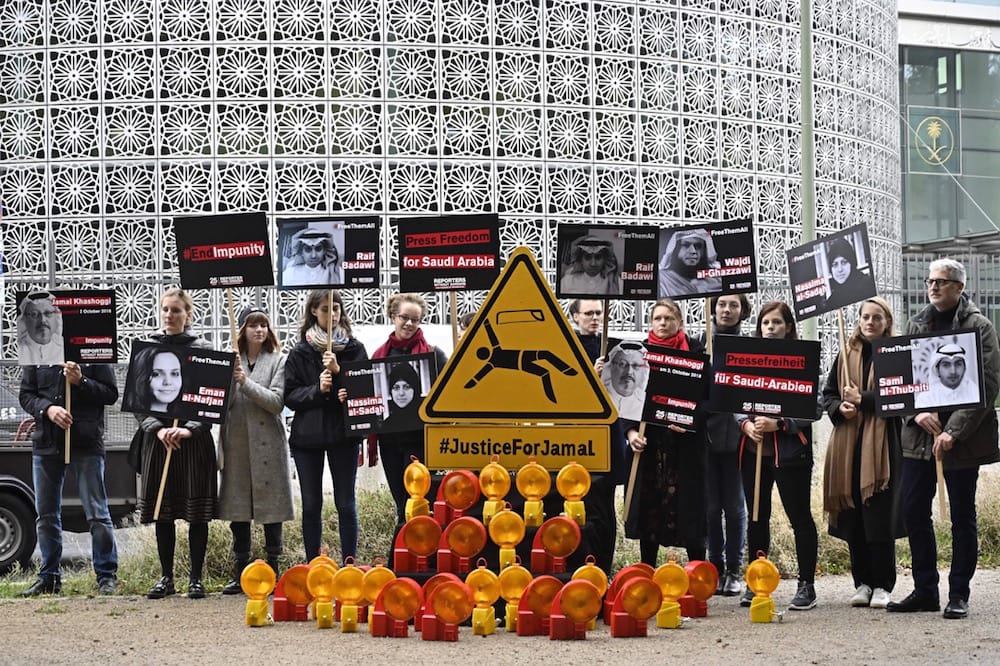 During an RSF protest, people hold placards depicting imprisoned blogger Raif Badawi (Up L), assassinated journalist Jamal Khashoggi (Bottom L) and other Saudi activists, outside the Saudi Arabian Embassy to Germany in Berlin, 1 October 2019, TOBIAS SCHWARZ/AFP via Getty Images