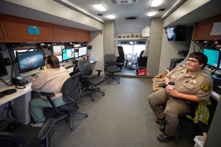 Sheriff's officers at a command post overseeing security for people voting from their car in a parking lot on the campus of Brigham Young University, in Provo, Utah, 30 June 2020, George Frey/Getty Images