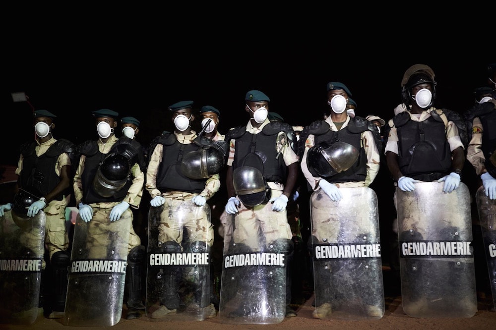 Soldiers of the Malian Gendarmerie are seen wearing masks and gloves during a sanitizing operation of the central market in Bamako, 4 April 2020, MICHELE CATTANI/AFP via Getty Images