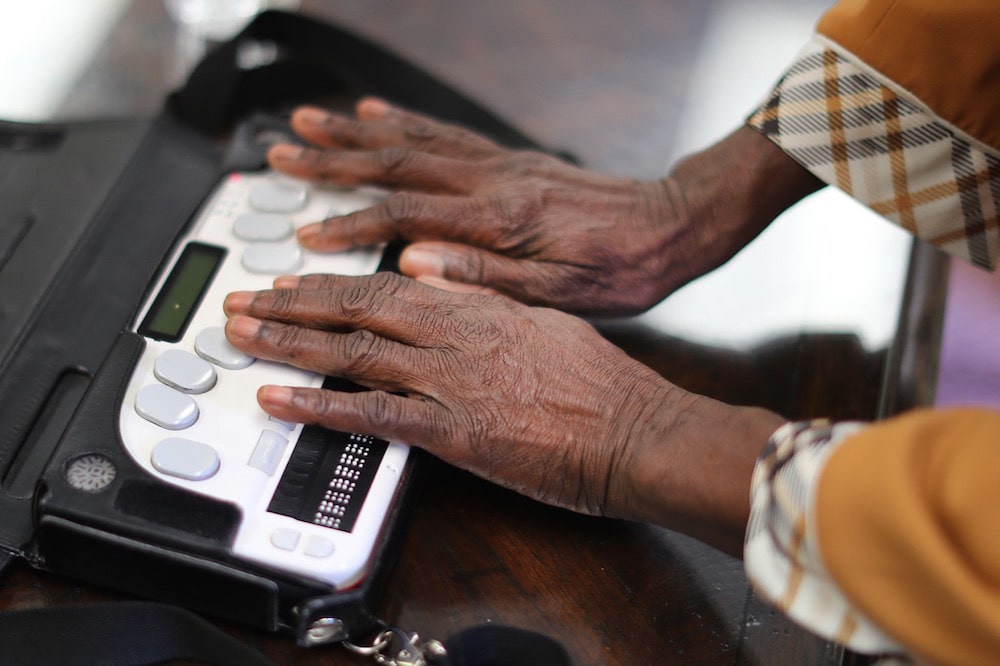 A blind Ugandan Parliamentarian types on a braille notemaker device that can print out braille documents and save notes and record speech, during a course on the technology in Newton, USA, 15 June 2018, John Tlumacki/Globe Staff (lmetro)