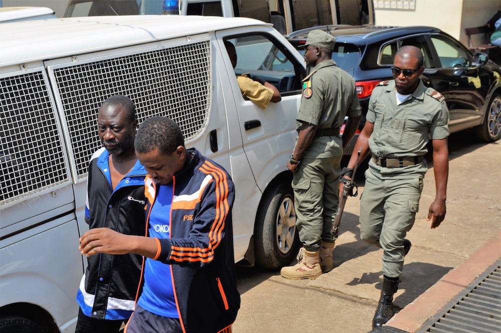 Men who are under arrest are seen at the military court in Yaoundé, Cameroon, 14 December 2018, STRINGER/AFP via Getty Images