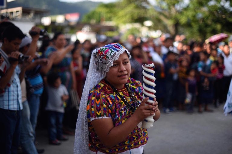 A woman takes part in an annual fair in honor of the "Virgen del Transito" (Transit Virgin), in Joyabaj municipality, Quiche departament, Guatemala, 8 August 2015, JOHAN ORDONEZ/AFP via Getty Images