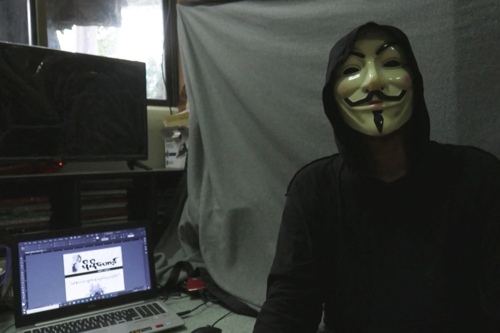 A screengrab provided via AFPTV video footage taken on 10 April 2021. A masked individual works on an underground newsletter to spread information in Yangon, Myanmar, amid internet outages as demonstrations continue against the military coup, -/AFPTV/AFP via Getty Images