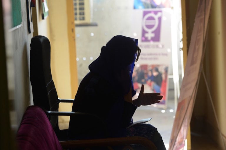 An NGO employee speaks during a call on a hotline dedicated to abortion, a topic that can result in harassment, in Peshawar, Pakistan, 17 December 2018, ABDUL MAJEED/AFP via Getty Images